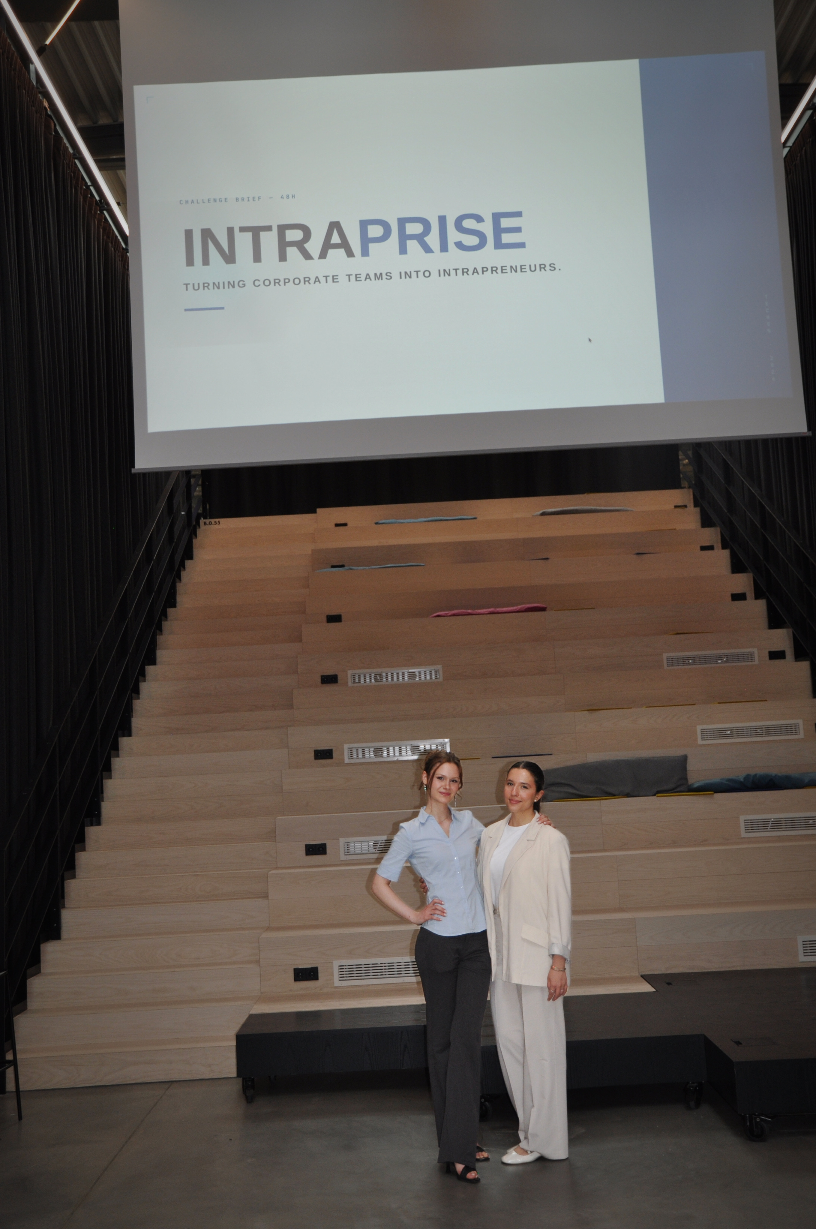 Two Intraprise founders in front of the challenge slide